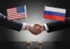 Handshake with US and Russian flags.