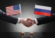 Handshake with US and Russian flags.