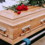 SAD NEWS: TV Star Gone Wooden casket with red roses on top