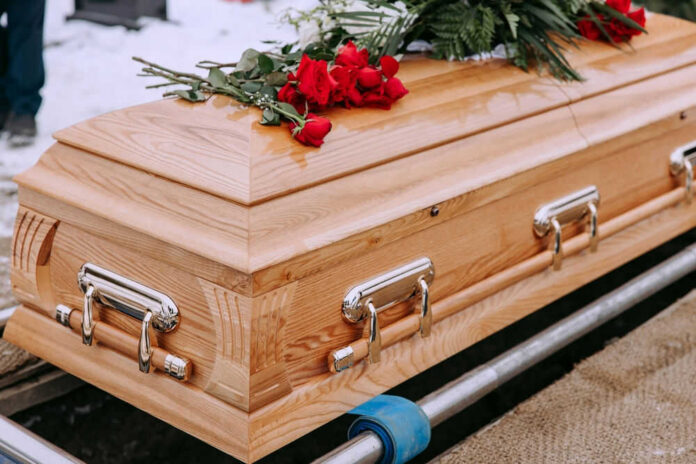 shutterstock2423034429jpg-1 Wooden casket with red roses on top