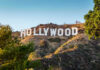 DOJ Greenlights Hollywood Giant – No Strings Hollywood Sign on a green hillside, sunny day.