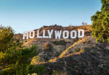 DOJ Greenlights Hollywood Giant – No Strings Hollywood Sign on a green hillside, sunny day.