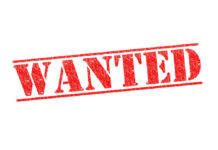 ALERT: Prison Break Sparks Manhunt Red WANTED stamp on white background.