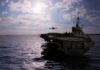 Three US Carriers Deployed Aircraft carrier at sea with jet approaching to land