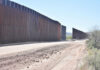 Judge FREEZES Wall – DHS On Trial Dirt road beside tall metal border wall