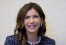 Kristi Noem Goes Public Gov Kristi Noem smiling indoors.