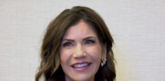 Gov Kristi Noem smiling indoors.