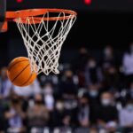 Basketball swishing through a hoop during a game