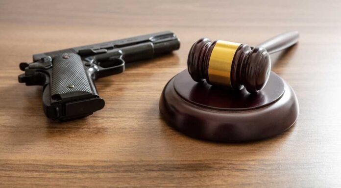 Crime,,Gun,Carry,And,Use,Punishment,Concept.,Judge,Gavel,And Judge's gavel and handgun on wooden table