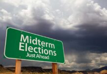 Latino Voters Revolt – Trump Hit Hard green roadside sign against a stormy sky