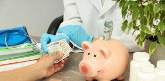 A patient handing cash to a healthcare professional in a medical setting