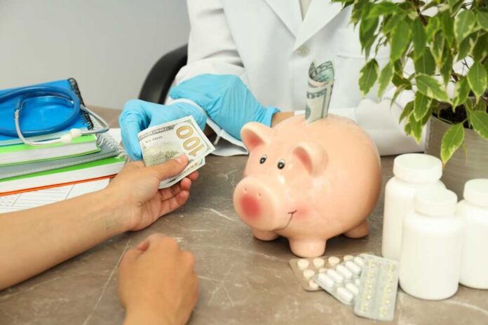 A patient handing cash to a healthcare professional in a medical setting