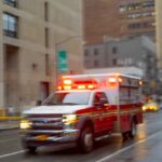 100-Foot Plunge – She’s Found Alive Ambulance with flashing lights driving on a wet city street