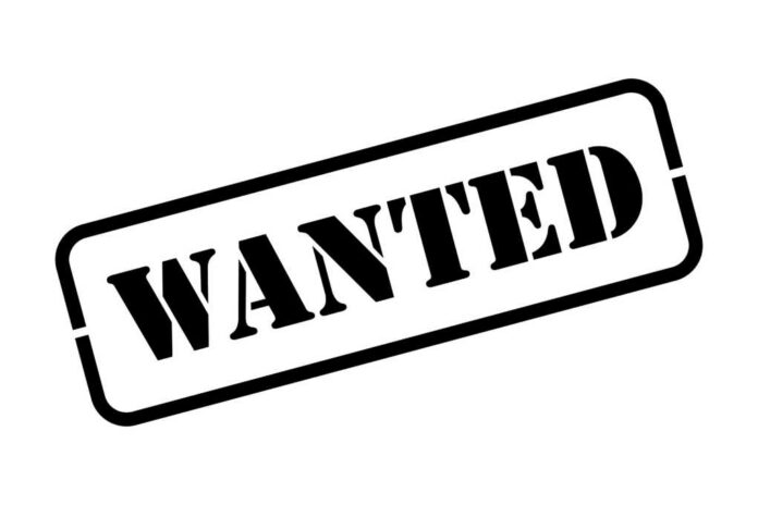 Wanted,Black,Rubber,Stamp,Vector,Illustration Paxton Lynch with border patrol vehicles and officers near a fenced hillside