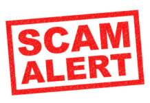 Red stamp with the words SCAM ALERT in bold letters