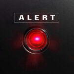 Detainers Ignored – 1,670 Walk Free Red alert light against black background, text ALERT.