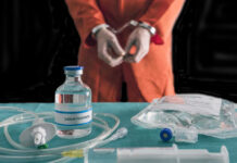 Execution Livestream STALLS – What Changed? Handcuffed person in orange suit with lethal injection supplies.